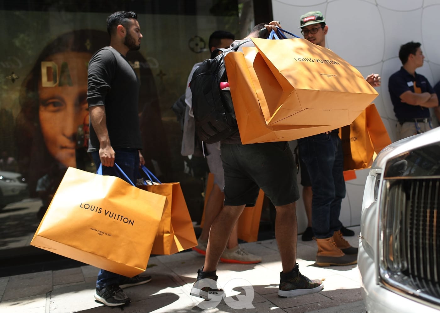 MIAMI, FL - JUNE 30:  Shoppers carry their Louis Vuitton bags from the store where they were selling limited edition supreme and Louis Vuitton collaboration items on June 30, 2017 in Miami, Florida.  The Louis Vuitton X Supreme collection pre-launched today in the American markets of Miami and Los Angeles with other pop-up locations worldwide that included Sydney, Tokyo, Seoul, Beijing, Paris and London.  (Photo by Joe Raedle/Getty Images)